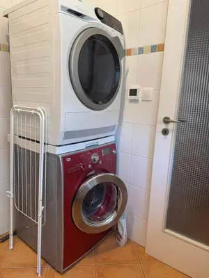 a washing machine sitting on top of a washer at Lochkov 53 in Prague