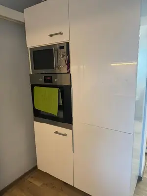 a kitchen with a microwave and a refrigerator at Lochkov 53 in Prague