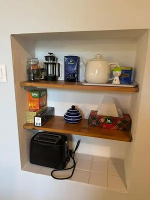 a shelf with a microwave and other items on it at Lochkov 53 in Prague