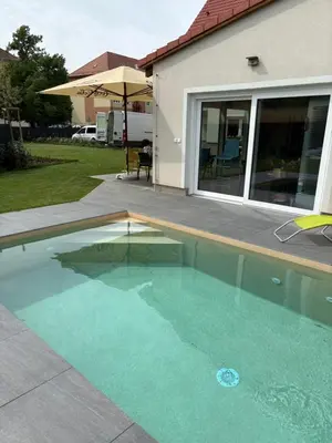 a swimming pool in front of a house at Mezidomí in Budyně nad Ohří