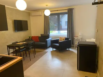 a living room with a couch and a table at Mezidomí in Budyně nad Ohří