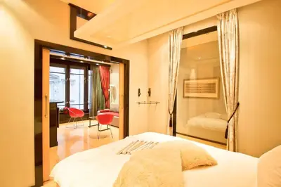 a bedroom with a white bed with a mirror at Apartment in the heart of Prague in Prague