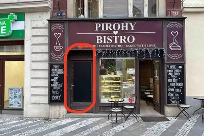 a store front of a store with an orange frame in front at Apartment in the heart of Prague in Prague