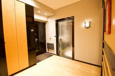 a hallway with a glass door leading to a bathroom at Apartment in the heart of Prague in Prague