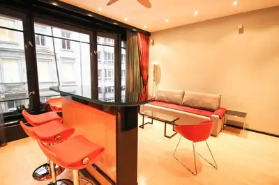 a living room with red chairs and a couch at Apartment in the heart of Prague in Prague