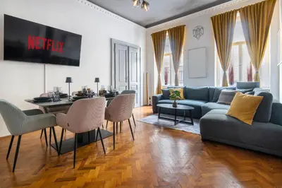 a living room with a blue couch and a table at 3 Bedroom - Central Superior-Flat 115m2 in Prague
