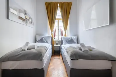 two beds in a room with a window at 3 Bedroom - Central Superior-Flat 115m2 in Prague