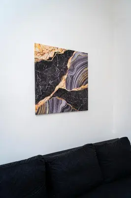 a piece of art on a wall above a couch at Victory Deluxe Suite in Prague