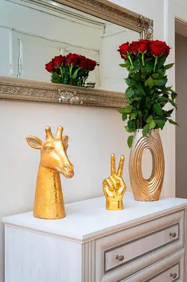 a dresser with two vases and a deer head on it at Victory Deluxe Suite in Prague