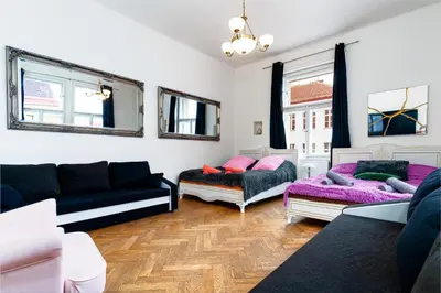 a living room with two couches and a couch at Victory Deluxe Suite in Prague