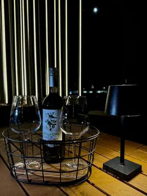 a bottle of wine and two wine glasses on a table at SYMPHONY No 501 Apartment MyMozart in Prague