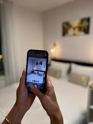 a person holding a cell phone in their hand at SYMPHONY No 501 Apartment MyMozart in Prague