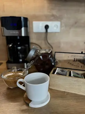 a cup of coffee sitting on top of a table at SYMPHONY No 501 Apartment MyMozart in Prague