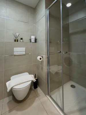 a bathroom with a toilet and a glass shower at SYMPHONY No 501 Apartment MyMozart in Prague