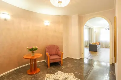 a living room with a chair and a table at Academia in Prague