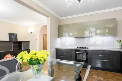 a kitchen with a vase of yellow flowers on a glass table at Academia in Prague