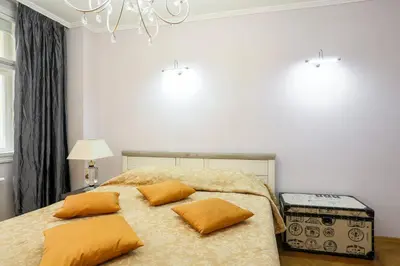 a bedroom with a bed with yellow pillows on it at Academia in Prague