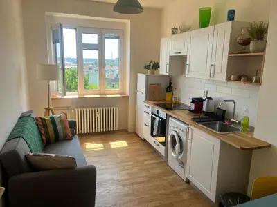 a small kitchen with a sink and a stove at Stylový a slunný byt s uměleckým nádechem v blízkosti centra in Prague