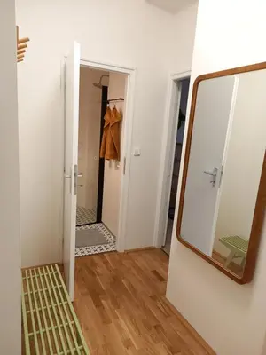 a mirror on a wall next to a bathroom at Stylový a slunný byt s uměleckým nádechem v blízkosti centra in Prague
