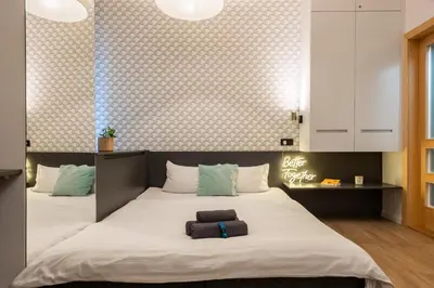 a bedroom with a bed with two towels on it at Lighthouse Apartment in Prague