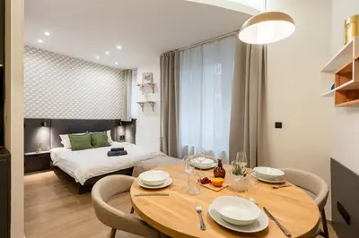 a room with a dining table and a bed at Lighthouse Apartment in Prague