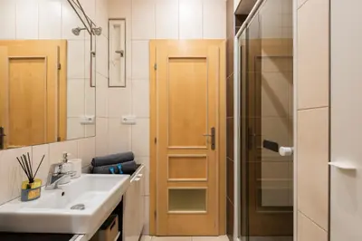a bathroom with a sink and a shower at Lighthouse Apartment in Prague