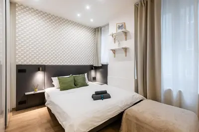 a bedroom with a bed with a suitcase on it at Lighthouse Apartment in Prague