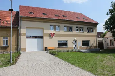a house with a white garage and a driveway at Penzion Piller in Chvalín