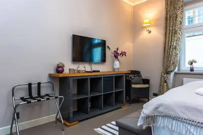 a bedroom with a tv on top of a shelf at Apartment Municipal house Prague 1 Old town in Prague