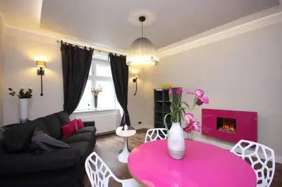 a living room with a pink table and a couch at Apartment Municipal house Prague 1 Old town in Prague