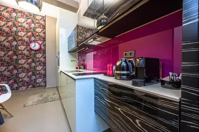 a kitchen with purple walls and a counter top at Apartment Municipal house Prague 1 Old town in Prague