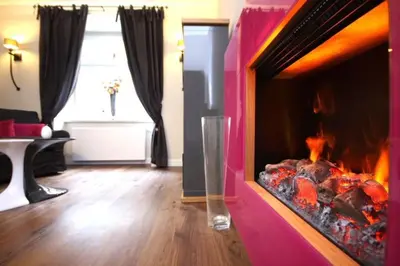 a living room with a fire place in the middle at Apartment Municipal house Prague 1 Old town in Prague