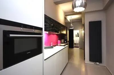 a kitchen with a black and white stove top oven at Apartment Municipal house Prague 1 Old town in Prague