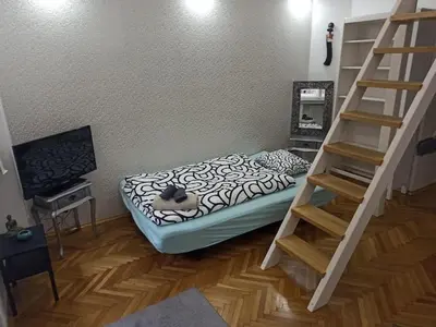 a room with a bed and a staircase in it at Unique apartment near Charles Bridge in Prague