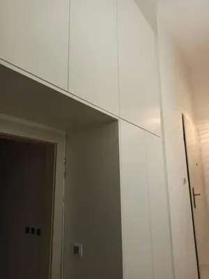 a white cabinet in a room with a door at Unique apartment near Charles Bridge in Prague
