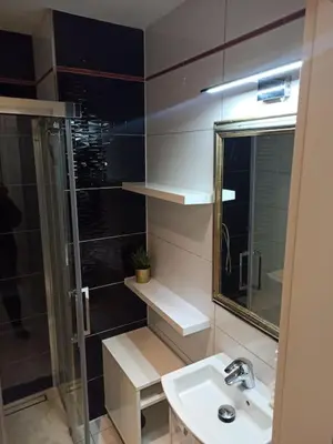 a bathroom with a sink and a shower and a mirror at Unique apartment near Charles Bridge in Prague