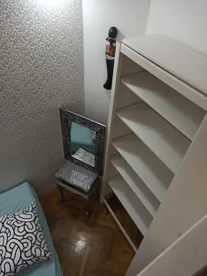 a closet with a shelf and a chair in a room at Unique apartment near Charles Bridge in Prague