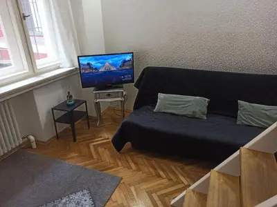 a living room with a couch and a flat screen tv at Unique apartment near Charles Bridge in Prague