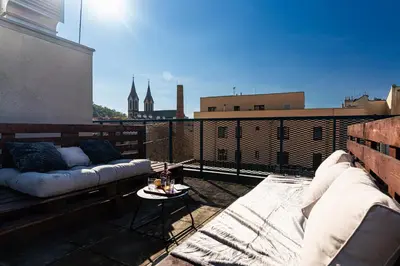 a balcony with a couch and a table on a building at Penthouse Tiger Deluxe in Prague