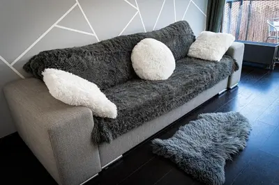 a couch with two pillows on it in a living room at Penthouse Tiger Deluxe in Prague