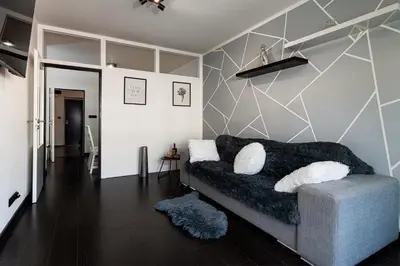 a living room with a couch and a wall at Penthouse Tiger Deluxe in Prague