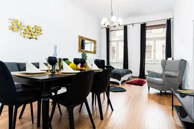 a living room with a dining room table and chairs at Black Diamond Suite in Prague