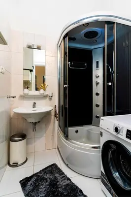 a bathroom with a washing machine and a sink at Black Diamond Suite in Prague
