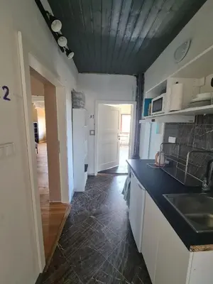 a bedroom with two beds and a couch in it at Guest Rooms in Private Home by Airport, Shared Bath, Non-Smoking, Contactless Check-in, No Staff, Quiet Stay, Short Stay in Kněžívka