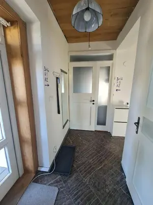 a living room with a couch and a bed at Guest Rooms in Private Home by Airport, Shared Bath, Non-Smoking, Contactless Check-in, No Staff, Quiet Stay, Short Stay in Kněžívka