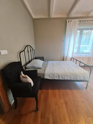 an empty living room with a table and a window at Guest Rooms in Private Home by Airport, Shared Bath, Non-Smoking, Contactless Check-in, No Staff, Quiet Stay, Short Stay in Kněžívka