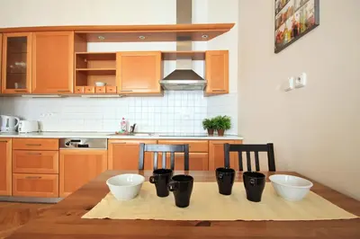 a kitchen with a table with four bowls on it at Quadrio Bedroom Central Apartment in Prague
