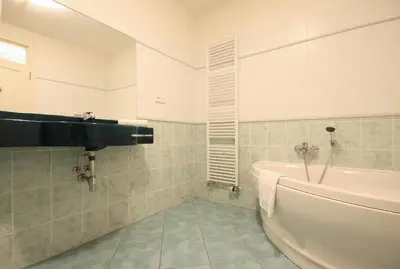 a bathroom with a sink and a bath tub at Quadrio Bedroom Central Apartment in Prague