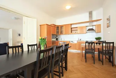 a kitchen and dining room with a table and chairs at Quadrio Bedroom Central Apartment in Prague