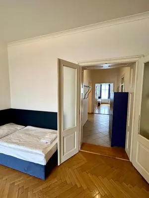 a bedroom with a bed and a door to a hallway at Quadrio Bedroom Central Apartment in Prague